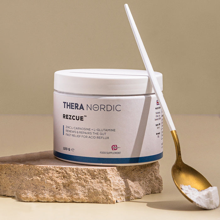 Container of Thera Nordic Rezcue supplement with a spoon on a stone surface.